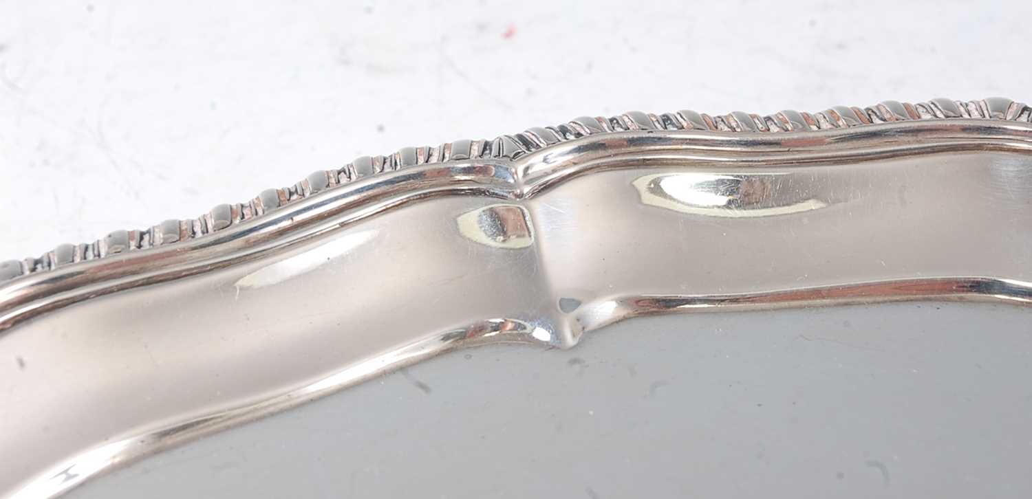 A late Victorian silver salver, having a gadrooned piecrust rim, raised on three claw and ball feet, - Image 2 of 4