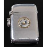 A late Victorian silver vesta, of hinged rectangular form, the cover inset with a compass dial,