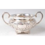 A George III silver twin handled sugar bowl, of squat circular form, having floral repousee
