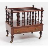 A late Victorian rosewood three-division music canterbury, having base drawer and on ring turned