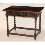 An antique joined oak side table, having a two-plank top over rosette blind carved frieze drawer,
