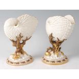 A pair of Royal Worcester porcelain Nautilus shell vases, each on bronzed and gilded moulded