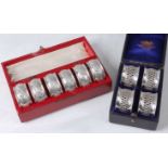 A cased set of six late Victorian silver and embossed napkin rings, each with vacant cartouche, 2.