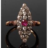 A late Victorian yellow and white metal, ruby and diamond marquise shaped cluster ring, comprising a