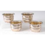 A set of four late Victorian silver table salts by Elkington & Co, each of oval bombe form with