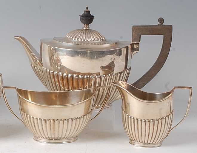 A George V silver three-piece tea set, comprising teapot, twin handled sugar and cream, each of