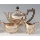 A George V silver three-piece tea set, comprising teapot, twin handled sugar and cream, each of