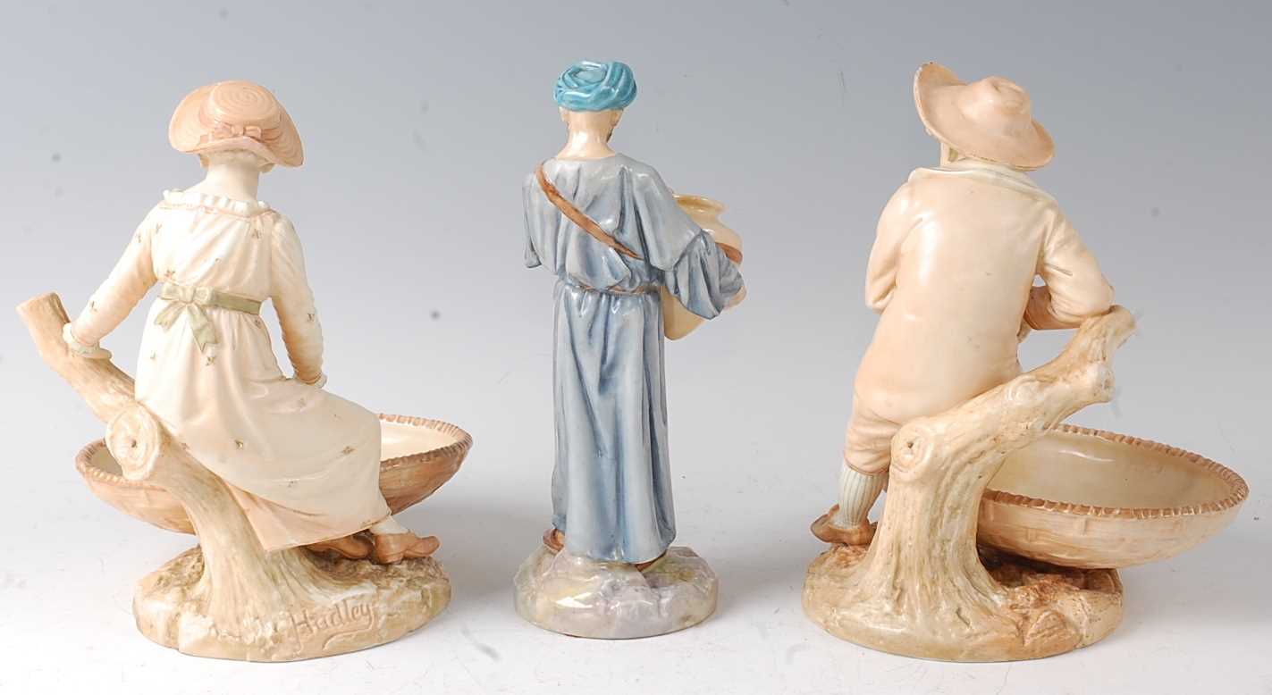 A pair of Royal Worcester figural comports by James Hadley, modelled as a boy and girl seated upon a - Image 2 of 2