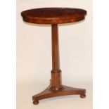 A Victorian rosewood pedestal games table, having a circular fixed top with satinwood and rosewood