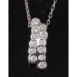 An 18ct white gold diamond bubble style pendant, featuring ten round brilliant cut diamonds in
