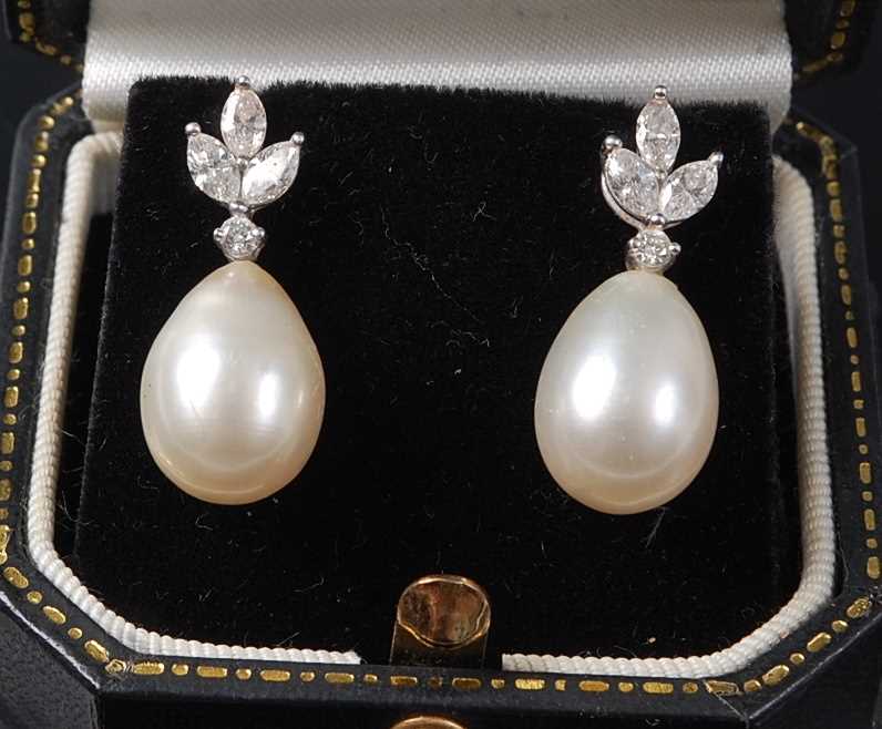 A pair of white metal, pearl and diamond drop earrings, the earrings each featuring a pearl drop