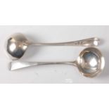 A pair of George III silver sauce ladles, in the Old English pattern, with monogrammed terminals,