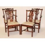 A set of twelve mahogany dining chairs in the Chippendale style, each having swept top rails and