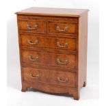 A George II style walnut chest, the rectangular quarter veneered top with crossbanding and feather-