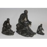 A graduated set of three late 19th century figures of the seated Mercury, after the antique, each