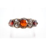 A vintage 9ct gold garnet and paste dress ring, in a lenticular setting with central round-cut