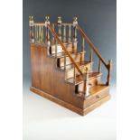 A Georgian style mahogany miniature chest of drawers modelled as steps leading to a podium, 43 cm