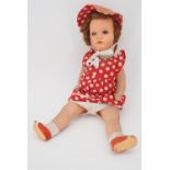 A 1930s composition doll in original costume, with painted features and sleeping eyes, with