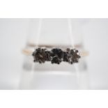 A vintage three stone brilliant-cut diamond ring, each of approximately .10ct, pellet and crown