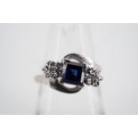 A sapphire and diamond twist set dress ring with central princess cut sapphire of approximately .