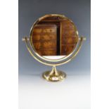 A brass dressing table mirror, 31 cm diameter