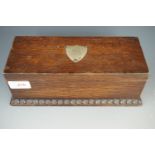 A late 19th / early 20th Century oak table-top cigarette box, with electroplate shield shaped