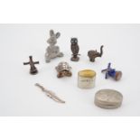 A small collection of white metal and other charms and miniatures, including an owl with turquoise-