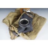 A Second World War British military gas mask and haversack