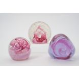 Three Caithness glass paperweights.