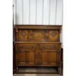 An old reproduction carved-oak court cupboard