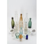 Various glass bottles, stoneware bottles and two feeding cups (2 trays)