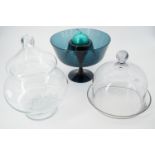 A free-blown glass cheese stand and cover, a covered glass bowl and a blue studio glass table