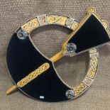 A very large bespoke jewellery display board modelled as a Celtic penannular brooch and set with