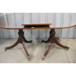 A quality older reproduction Regency style mahogany two-pillar dining table with single leaf.