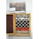 A travelling chess set and dominoes