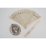 A Victorian bone brise fan, a paper knife and miniatures.