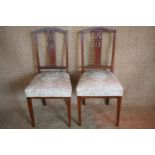 A pair of Edwardian Sheraton revival inlaid mahogany salon or bedroom chairs