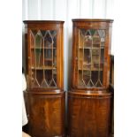 A pair of reproduction Georgian astragal-glazed mahogany standing corner cabinets, 182 cm and 185