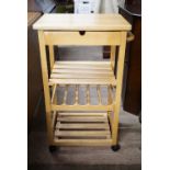 A contemporary pine kitchen trolley