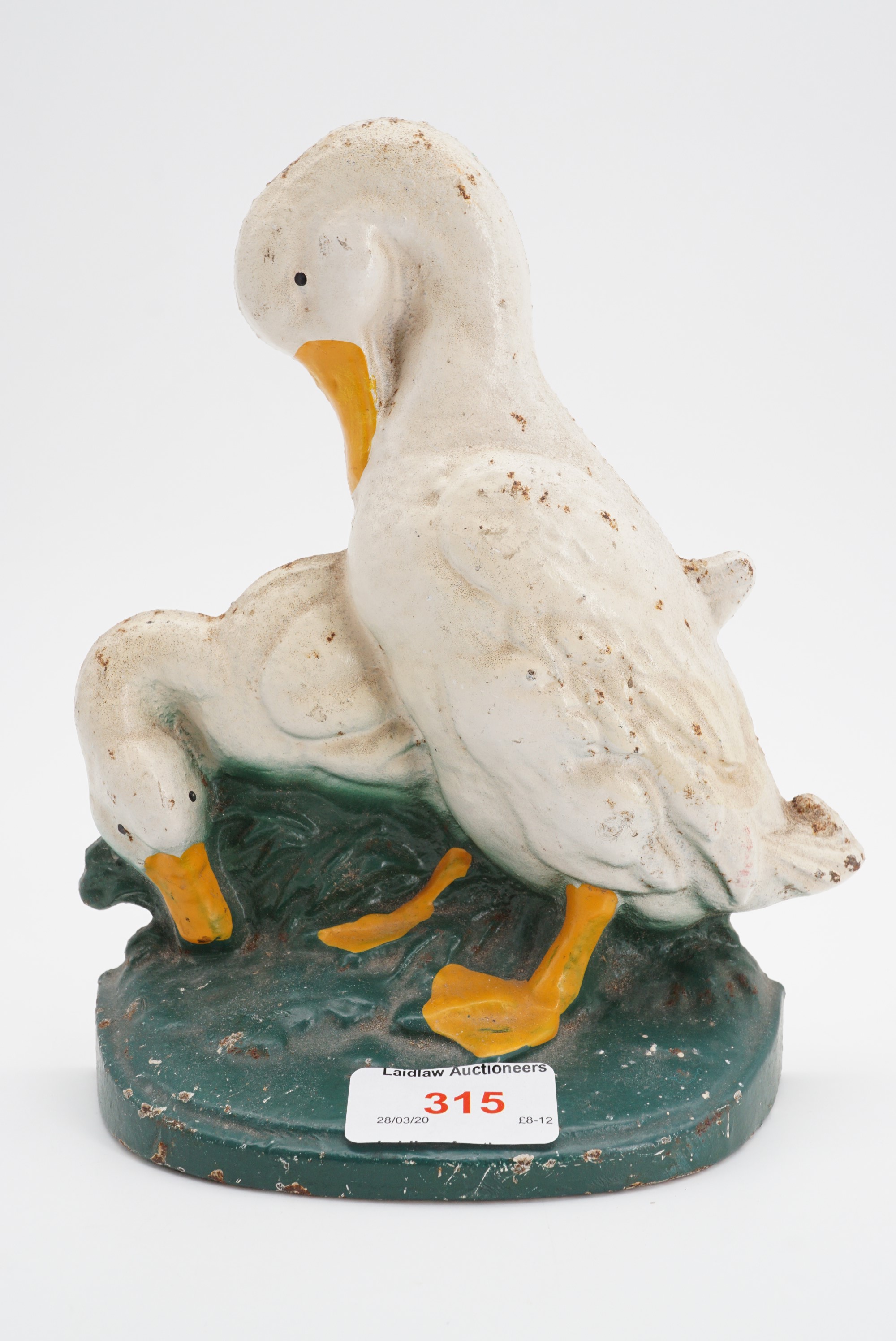 An enamelled cast iron door stop modelled as geese, 19 cm
