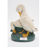An enamelled cast iron door stop modelled as geese, 19 cm