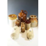 A quantity of stoneware, including flagon, two hot water bottles, and two lidded jars etc