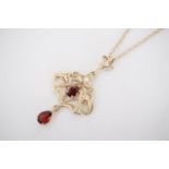A 9ct gold, garnet and seed pearl pendant necklace of Art Nouveau style, in an openwork arrangement,