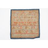 A 19th Century needlework alphabet sampler by Mary Ann Pratt aged 9 years, lined with blue cotton,