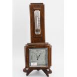 An oak cased aneroid barometer, 46 cm high