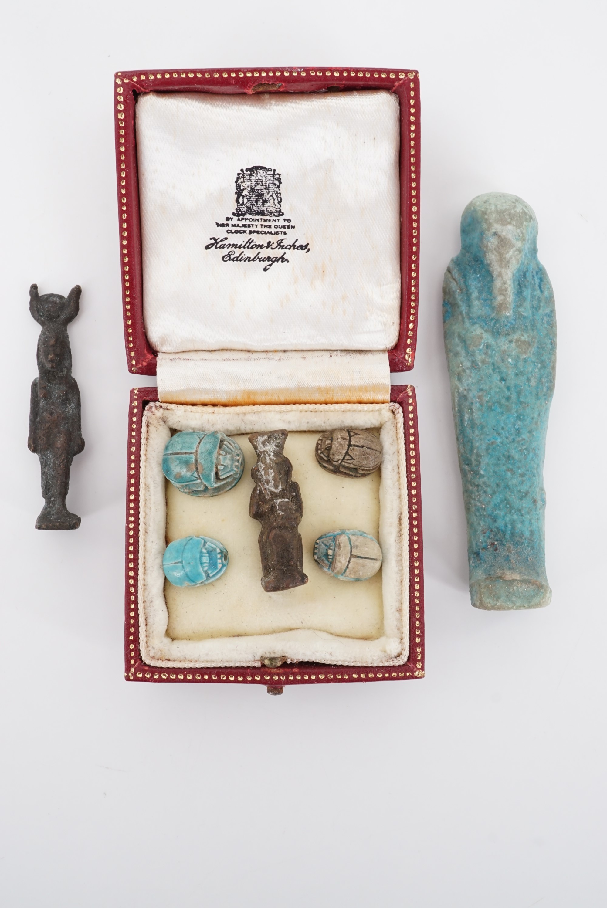 An Egyptian ushabti figurine, two other figures and scarabs