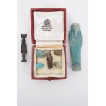 An Egyptian ushabti figurine, two other figures and scarabs