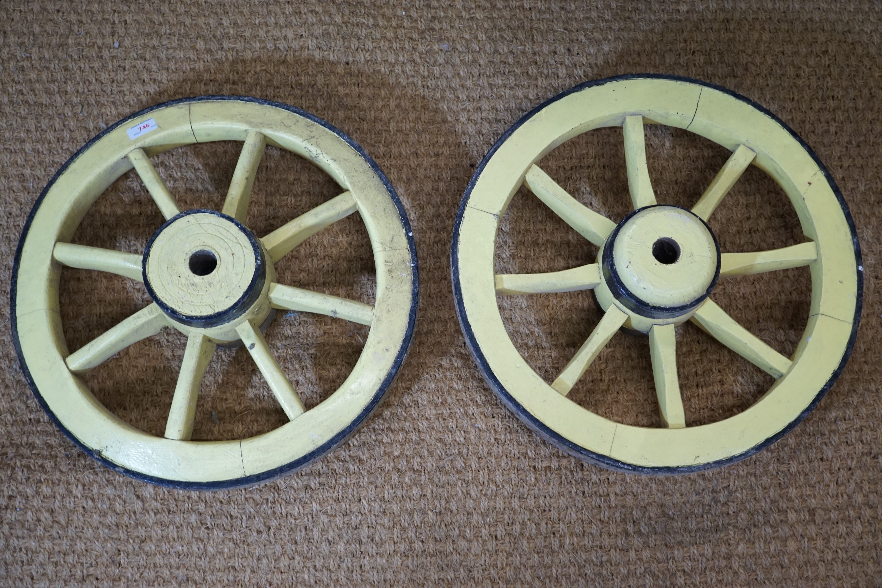 A pair of antique wooden small cart wheels with iron tyres, 50 cm