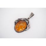 A contemporary white metal and sun-spangled amber pendant, the surmount of organic design, 6.5 cm