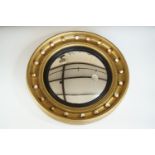 A large Regency style convex wall mirror, in gilt gesso and wooden frame, first half 20th Century,